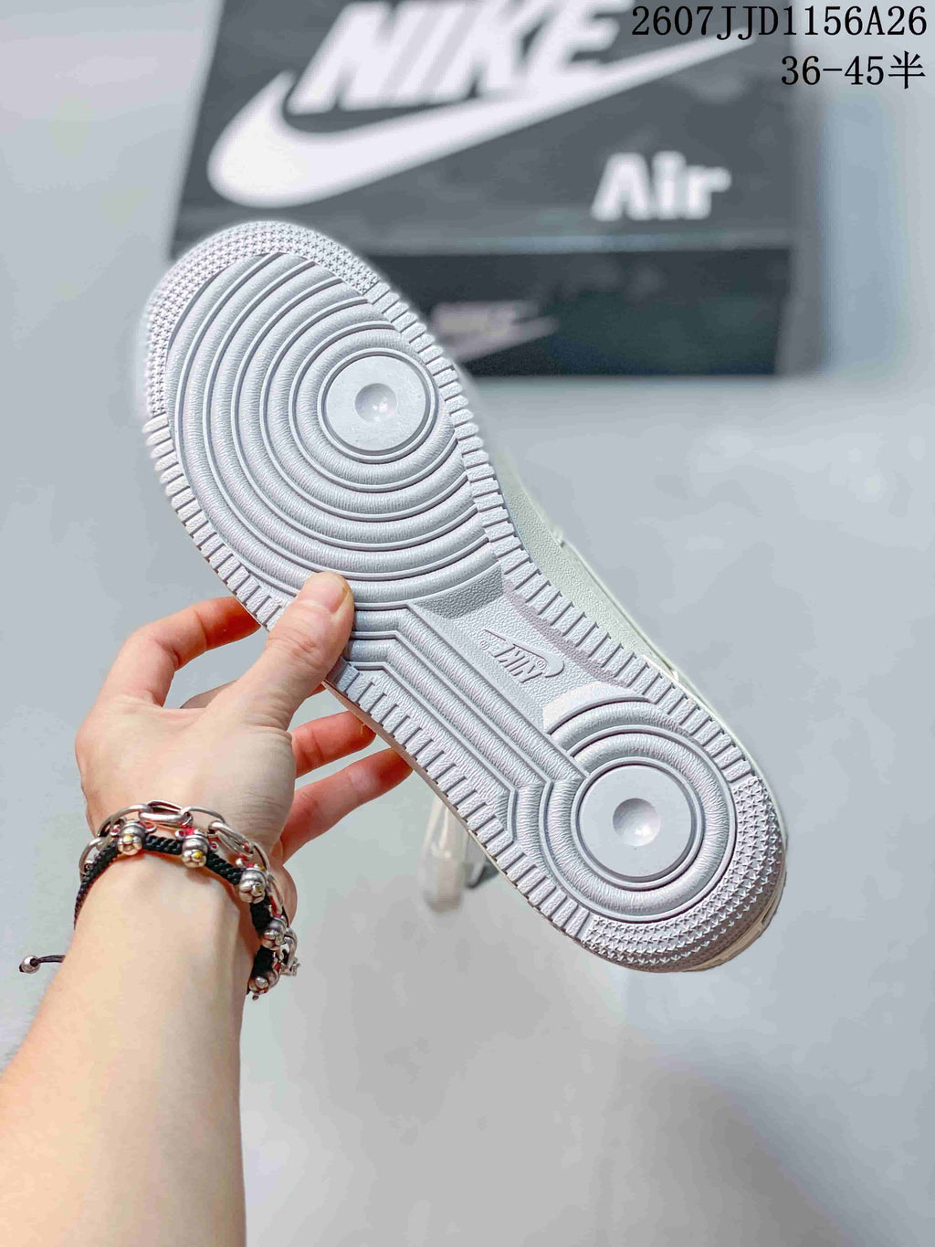 Close-up of the white textured outsole showing concentric circular tread patterns and Air branding.