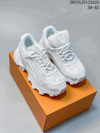 Pair of white Louis Vuitton Summit chunky sneakers displayed on an orange shoe box, showing mesh panels, layered overlays, and lugged soles.