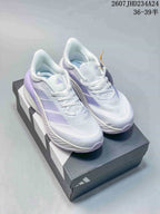 Pair of white and lavender adidas low-top sneakers displayed on an adidas shoebox.
