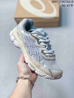 Three-quarter side view of the ASICS GEL-NYC sneaker showing the layered panels, mesh upper, and segmented sole.