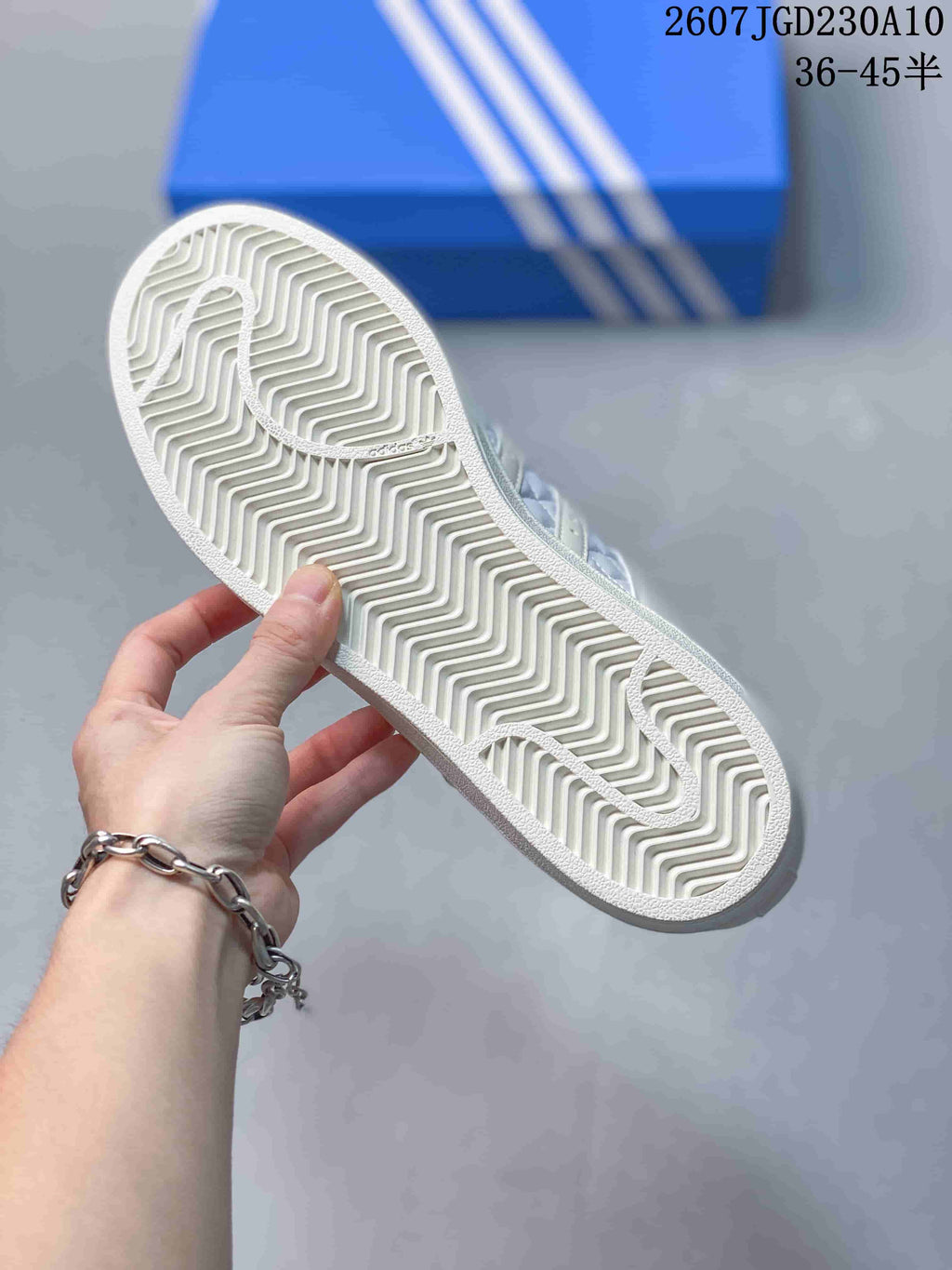 Close view of the white rubber outsole with a zigzag traction pattern.