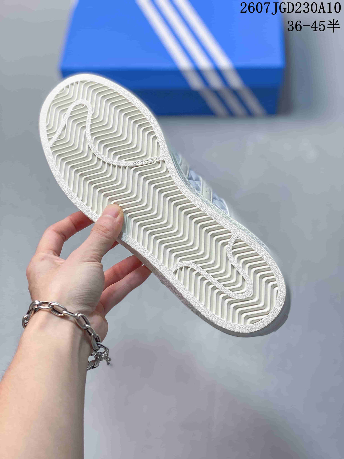 Close view of the white rubber outsole with a zigzag traction pattern.