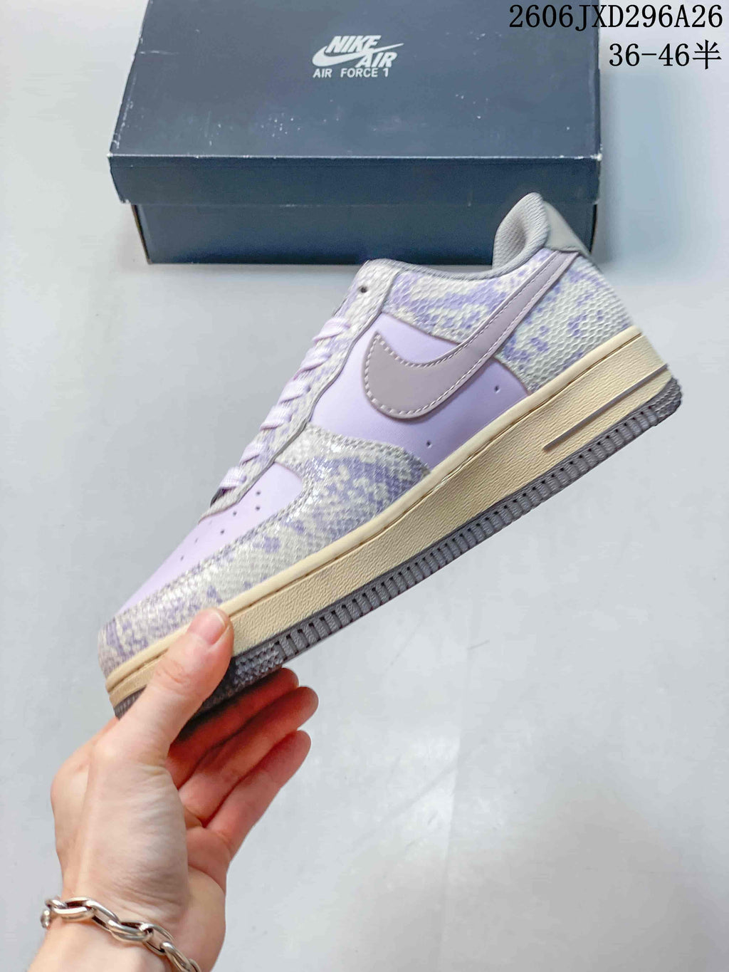 Side view of a lavender Nike Air Force 1 with patterned overlays and cream-colored midsole