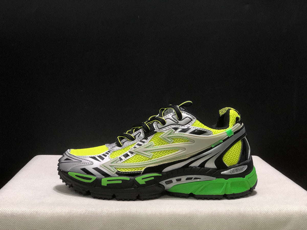 Lateral side view showing the large layered side detailing, black heel structure, and green midsole section.