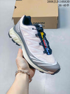 Side profile of the Salomon XT-6 sneaker in pink, gray, and navy
