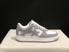 Single side profile highlighting the grey star panel, white midsole and textured grey outsole.