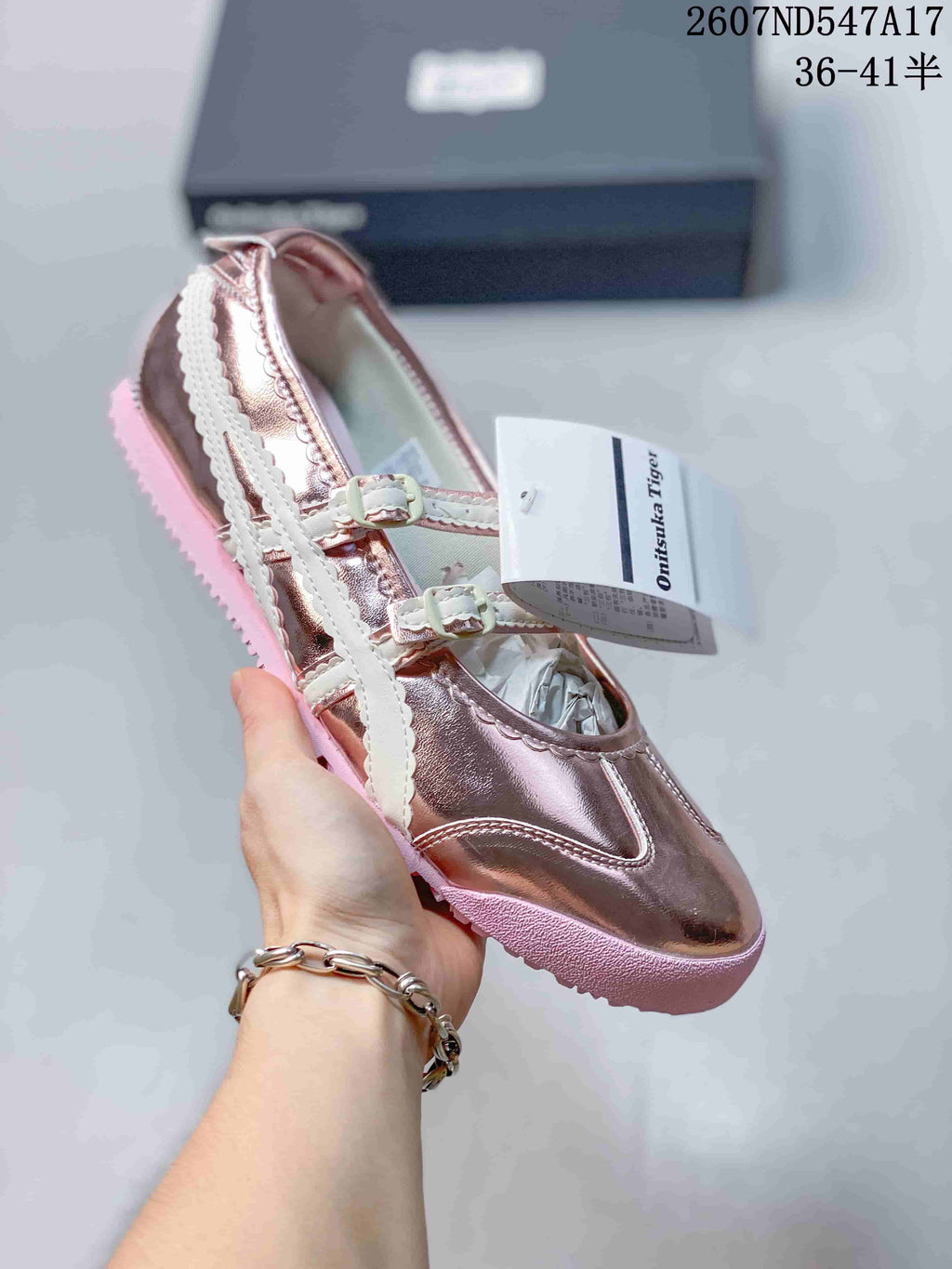 Rose-gold metallic Mary Jane sneaker with white straps and a pink-toned sole.