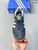 Top view of the sneaker showing dark laces, white collar padding, woven-texture panels, and adidas Originals tongue branding.