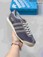 Angled side view showing the low-top silhouette, three-stripe details, contrasting toe cap, and gum outsole.