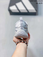 Rear view of a silver gray sneaker showing the heel pull tab, padded collar and outsole tread