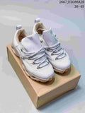 Pair of light gray On and LOEWE low-top sneakers displayed on a shoebox, with the style code and size range visible at the top right.