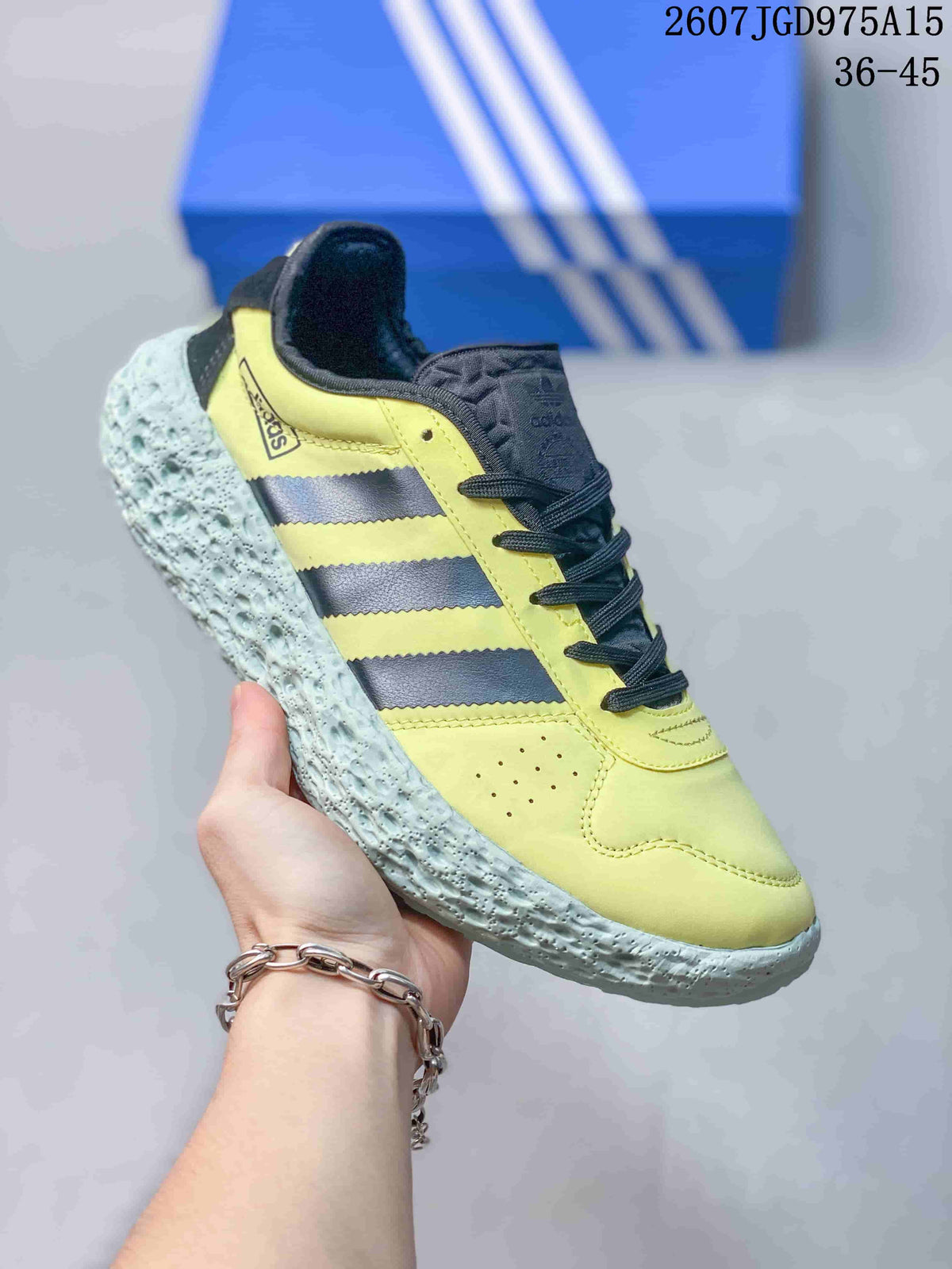 Angled side view showing the yellow and black upper, black laces, and pale textured outsole.