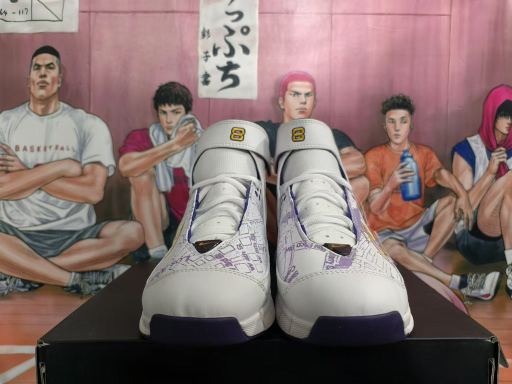 Front view of high-top sneakers showing white uppers, purple map-style print, gold accents, and number 8 tongue details.