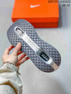 Underside view of a Nike Vomero Premium sneaker showing the patterned rubber outsole and central cushioning details.