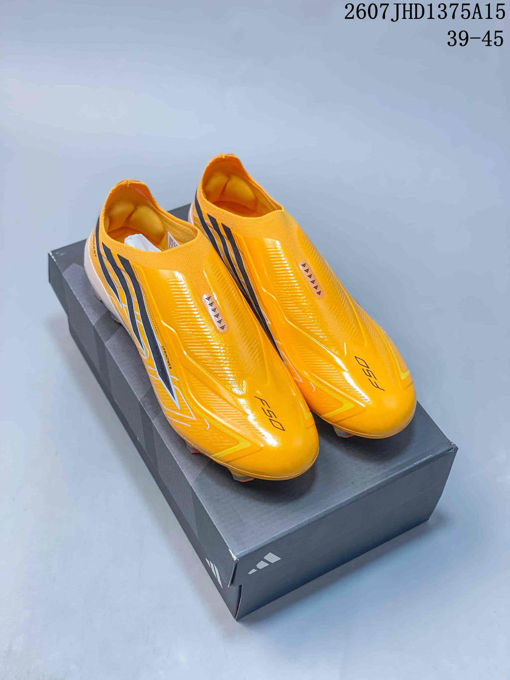 Pair of yellow and black adidas F50 Elite soccer cleats displayed on a shoebox; image text shows style code 2607JHD1375A15 and size range 39–45.