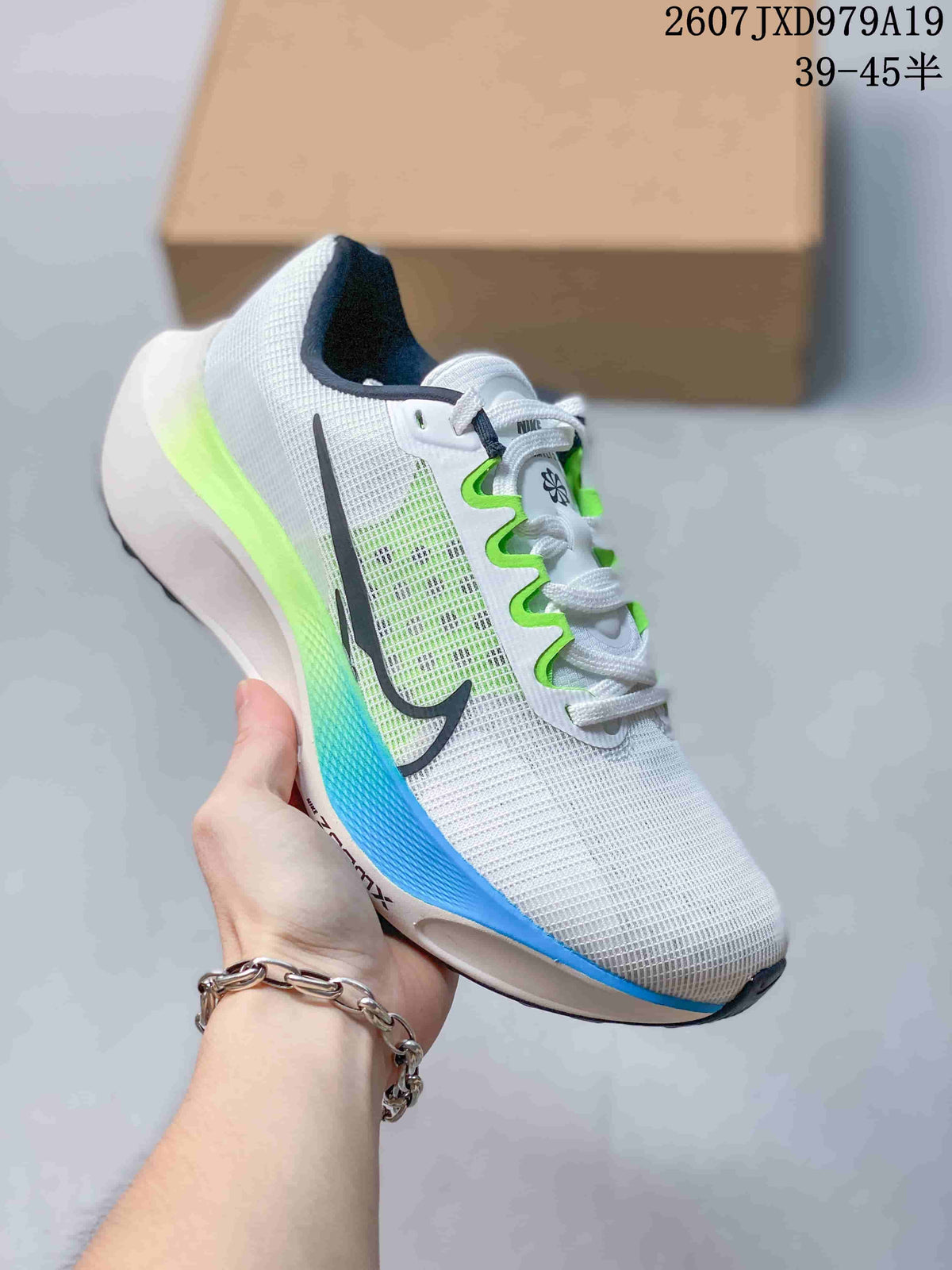White Nike Zoom Fly 5 PRM sneaker with black branding and bright green and blue sole accents.