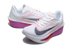 White Nike Zoom Fly 6 shoes with black swooshes and pink-purple midsole accents