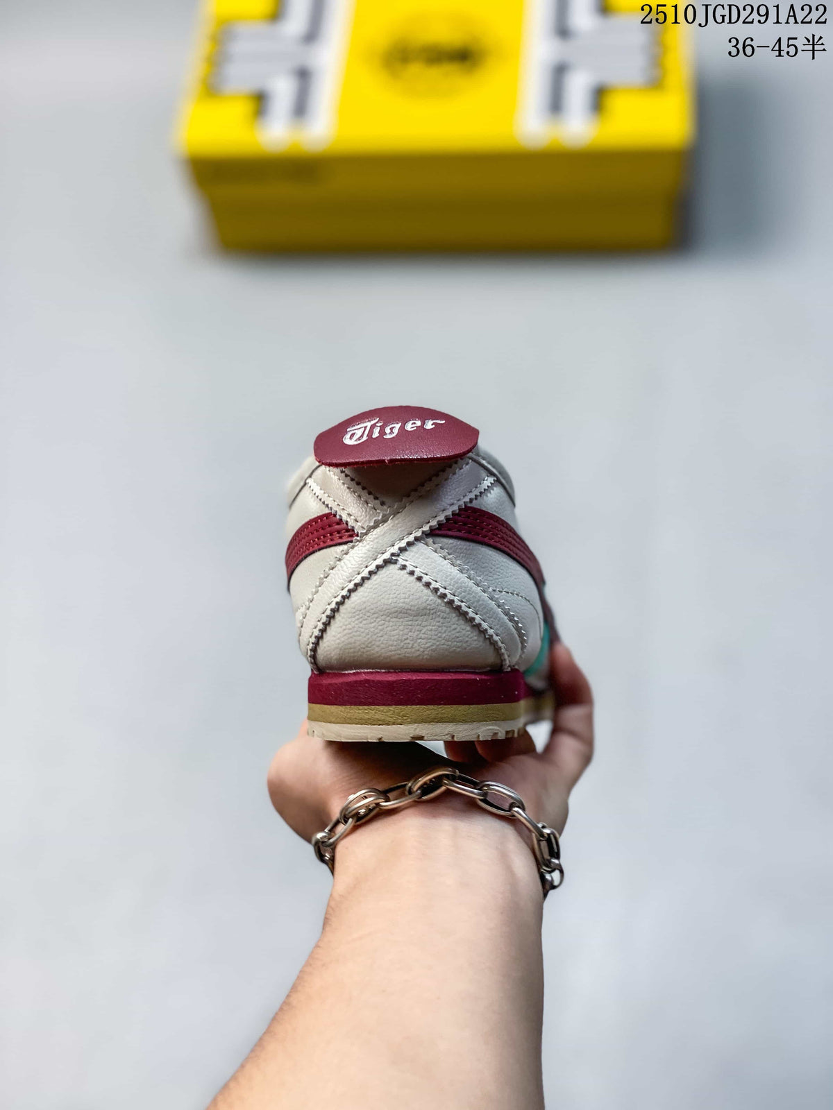 Rear view of a white Onitsuka Tiger sneaker with burgundy heel detailing and a layered outsole.