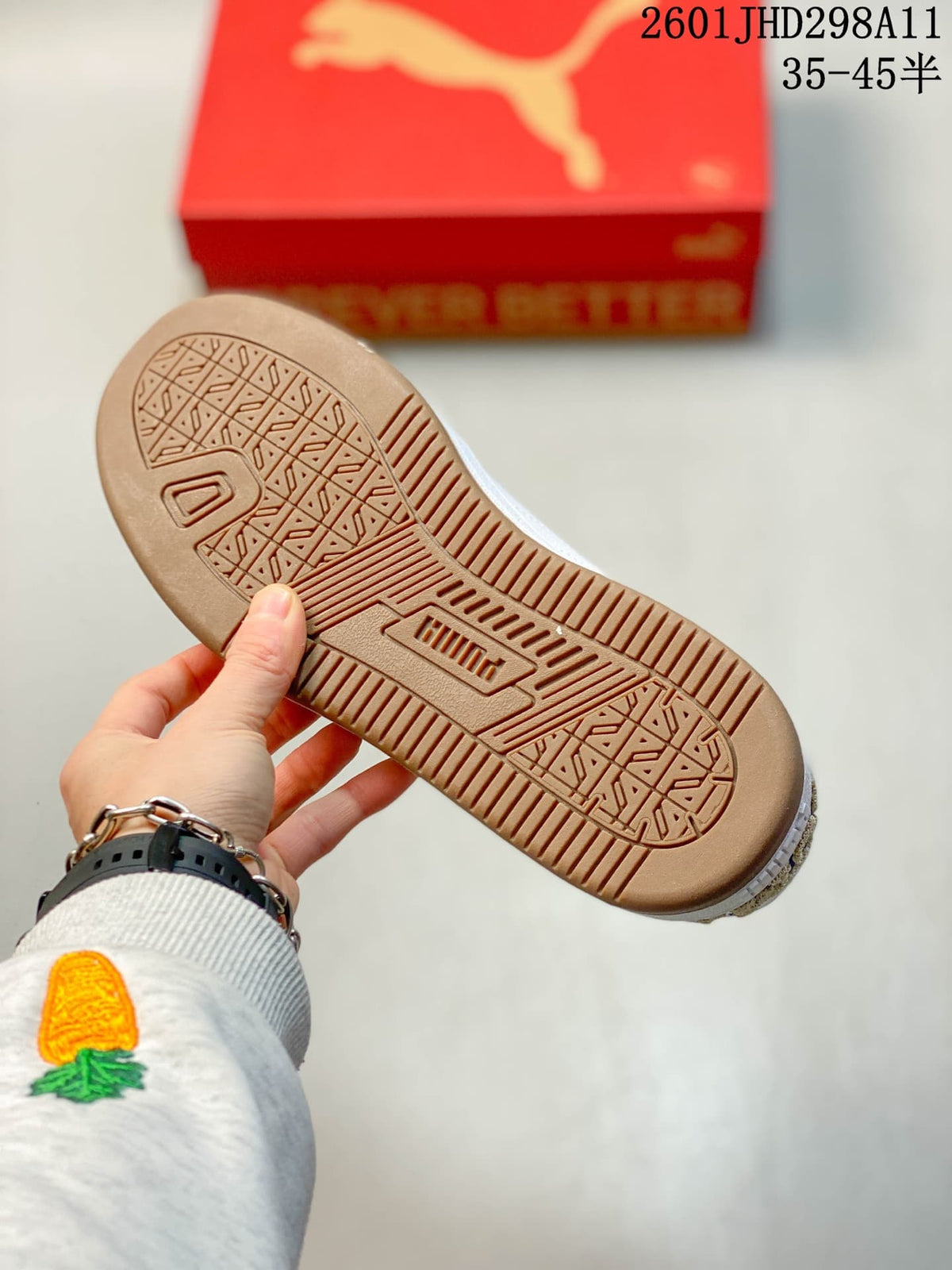 Underside of a sneaker showing the gum-toned patterned outsole and tread.