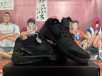 Angled view of black basketball shoes showing the side profile, perforated toe and heel details