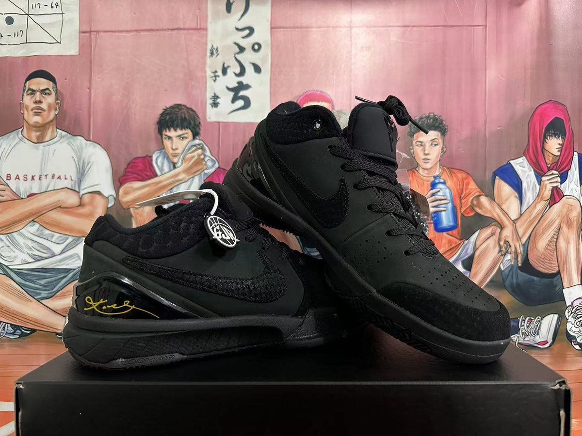 Angled view of black basketball shoes showing the side profile, perforated toe and heel details