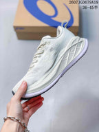 Side view of a white ASICS running sneaker showing the mesh-textured upper, lace area, layered midsole, and dark outsole edge.