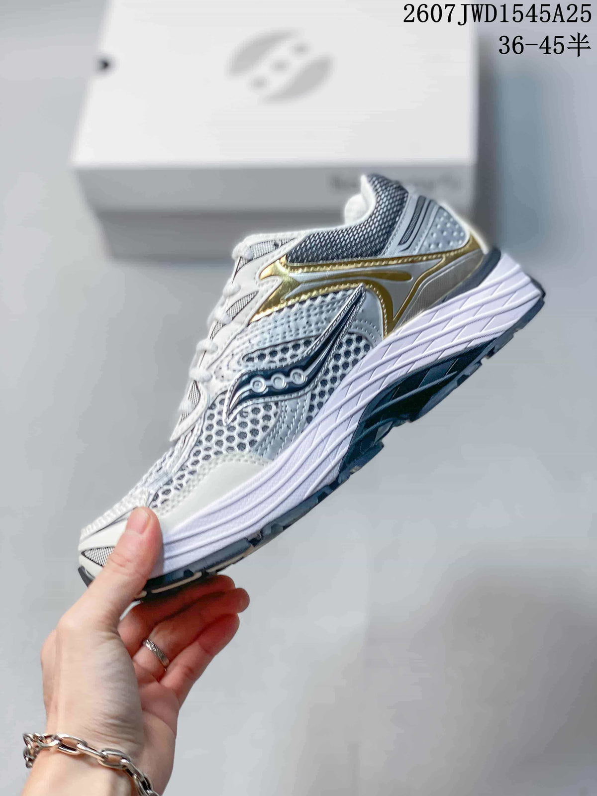 Side profile of the Saucony sneaker showing the layered upper, side branding and sculpted midsole.