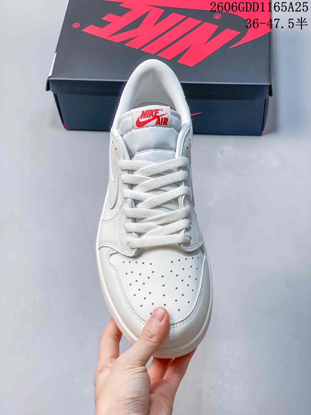 Front view of the sneaker showing white laces and perforations on the toe.
