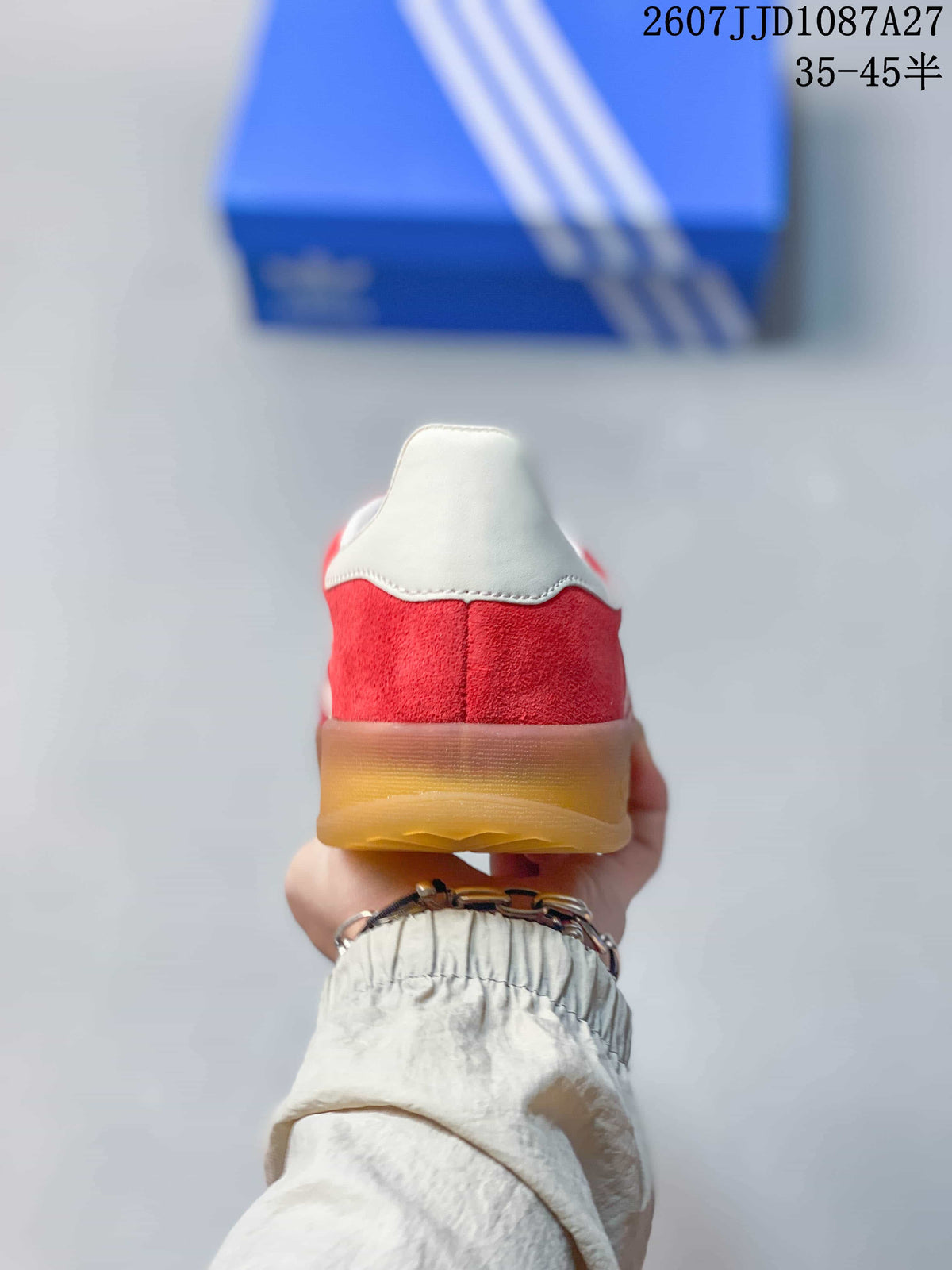 Rear view showing the red heel, white collar and gum-colored outsole.