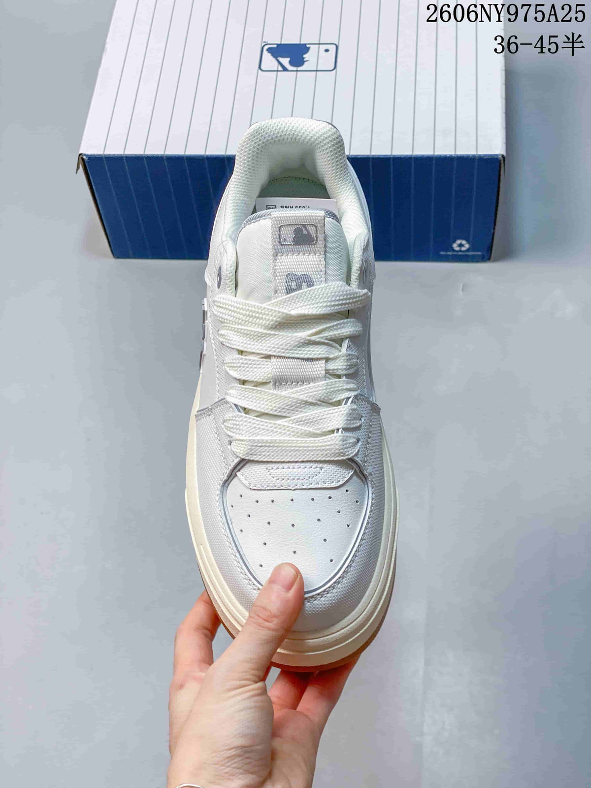 Top view of the sneaker showing the lace-up closure, padded tongue, perforated toe panel, and side detailing.