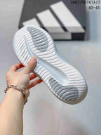 Close-up of the sneaker outsole showing a white patterned tread with grey traction sections.