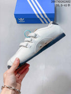 Side view showing the low-profile shape, three straps, and dark outsole