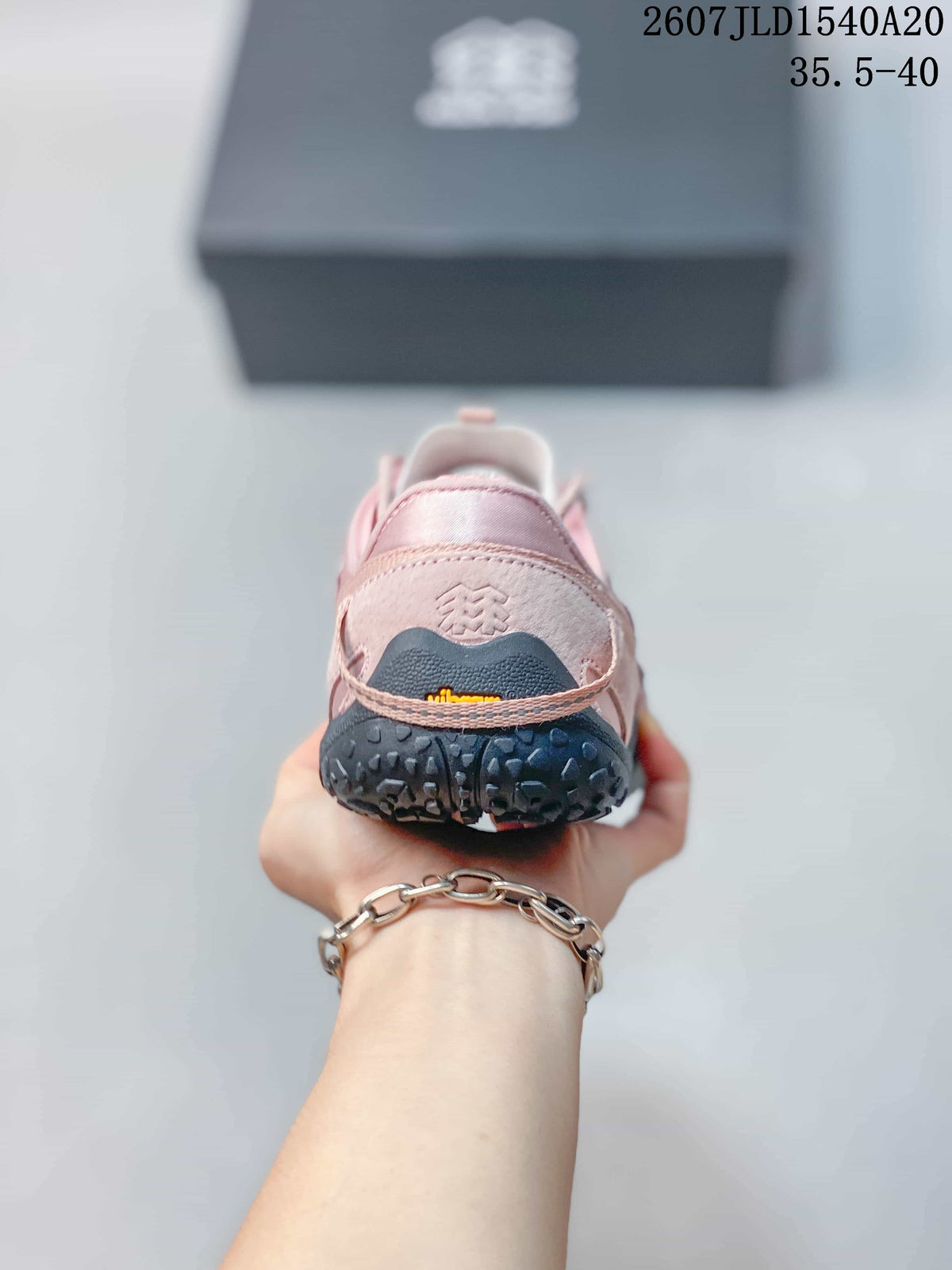 Rear view of the pink sneaker showing the padded heel, black heel section, and textured outsole.