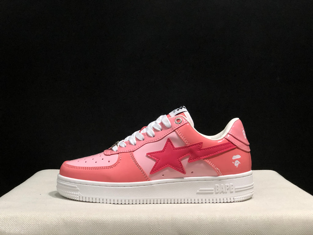 Side profile of a pink BAPE Sta sneaker showing the layered star-shaped side graphic and white outsole.