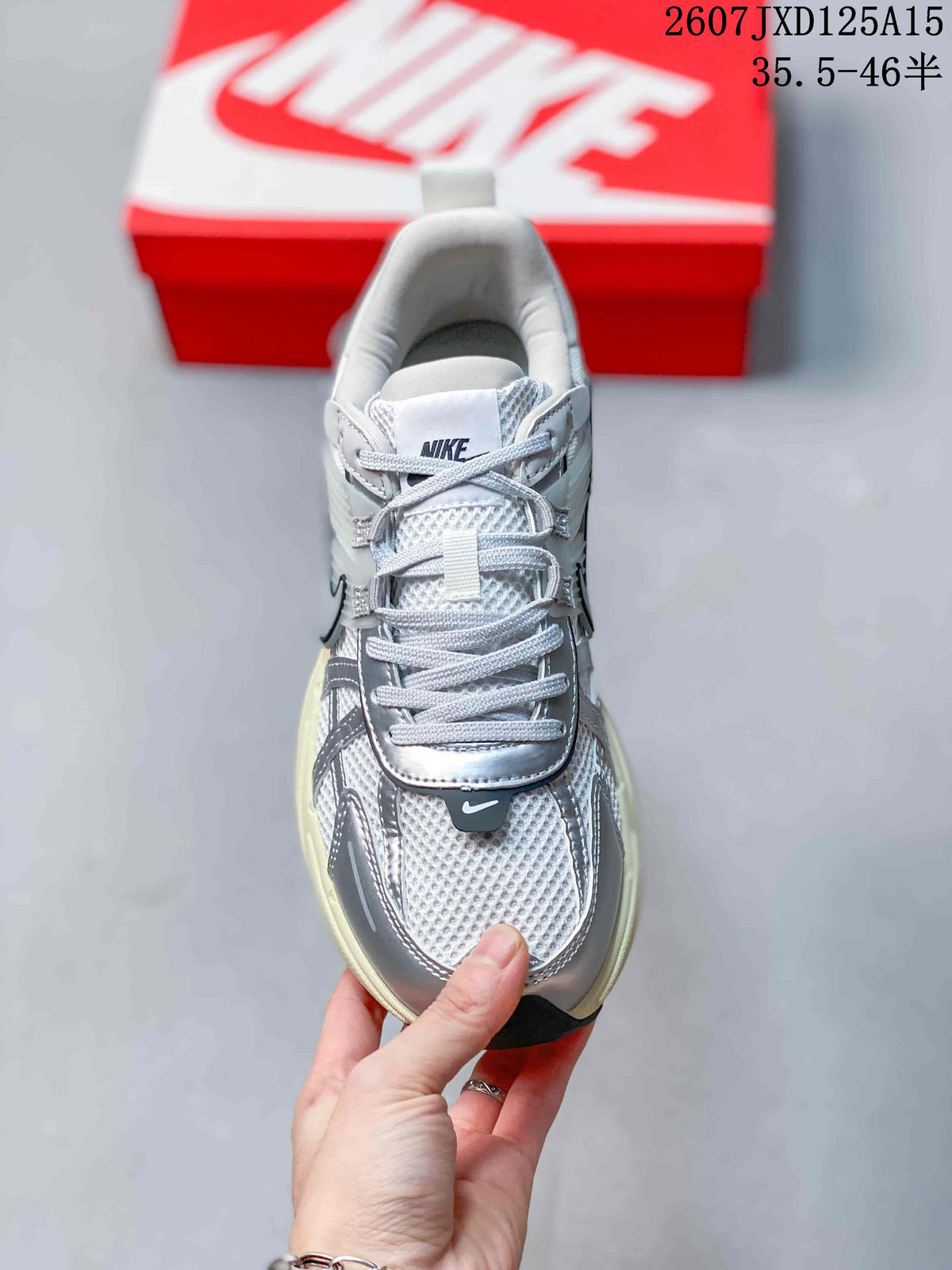 Top view of the sneaker showing the mesh toe box, layered silver overlays, flat laces and Nike tongue branding.