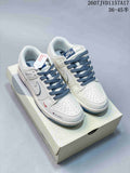 Pair of white and blue low-top sneakers displayed on a shoebox, with blue laces and style code 2607JVD1157A17 visible above.