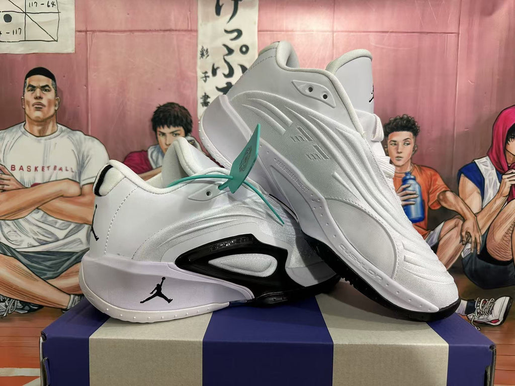 Angled view of white Jordan sneakers showing layered upper detailing and black accents