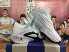 Angled view of white Jordan sneakers showing layered upper detailing and black accents