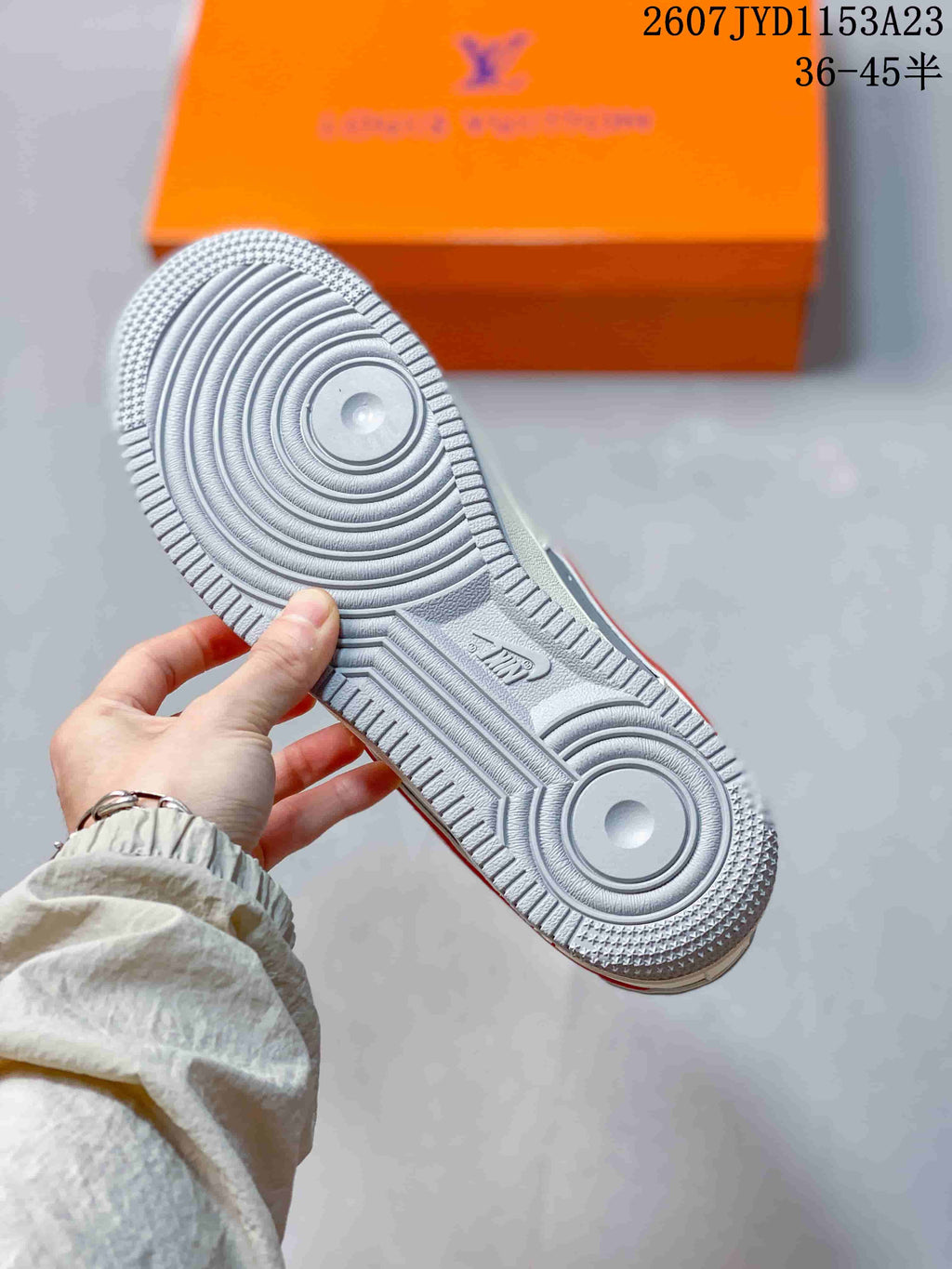 Close view of the textured light-grey rubber outsole with concentric circular tread patterns.
