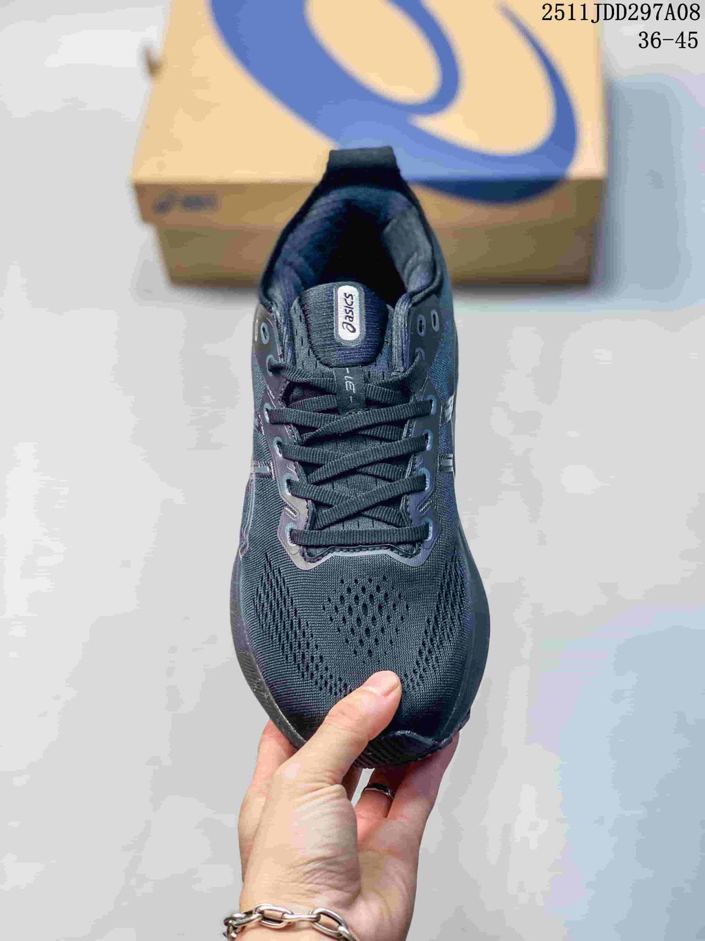 Top view of the dark gray lace-up sneaker showing the ASICS tongue label, eyelets, laces, and textured forefoot.
