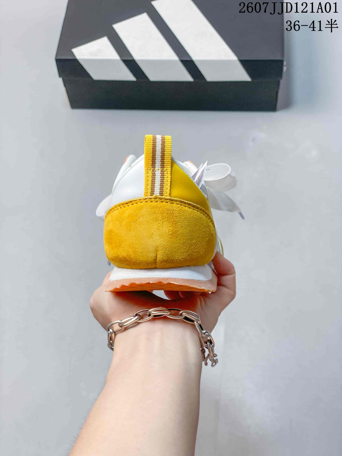 Rear view of the yellow and white adidas VS JOG 2.0 sneaker.