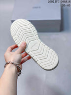 View of the textured white rubber outsole with SMFK branding