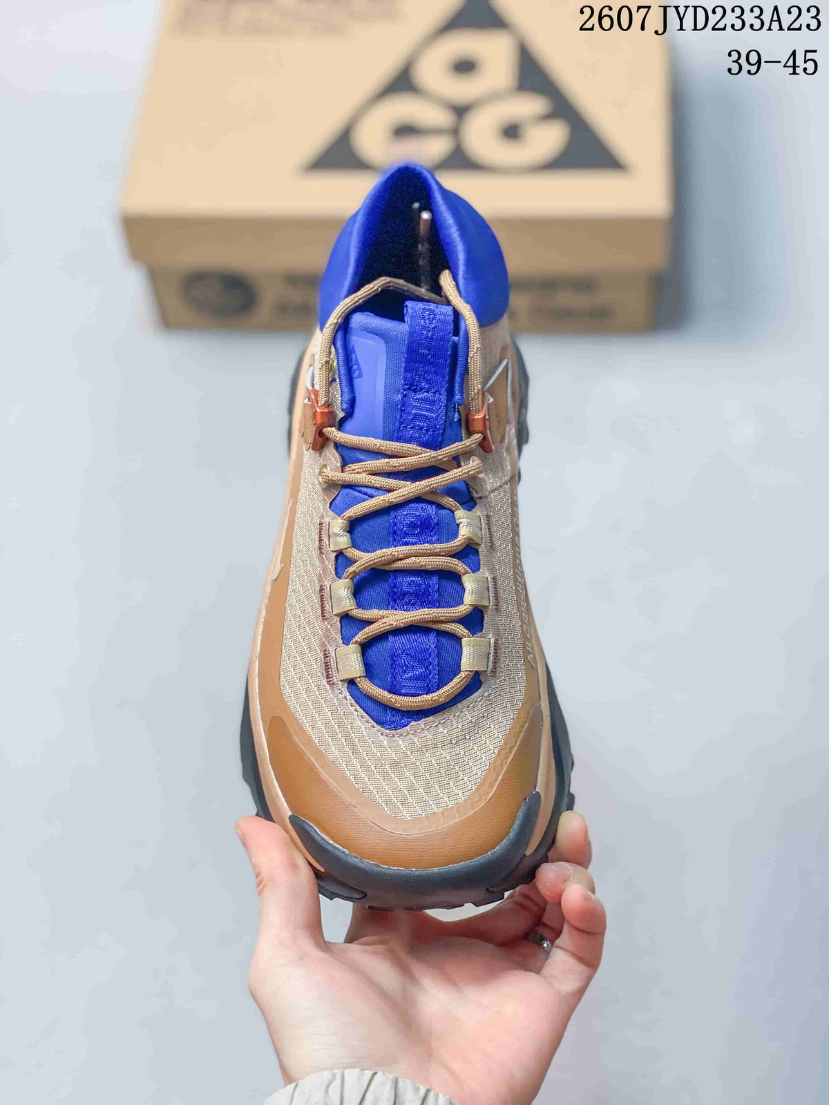 Top view showing the tan laces, blue tongue, textured upper, and structured toe area.