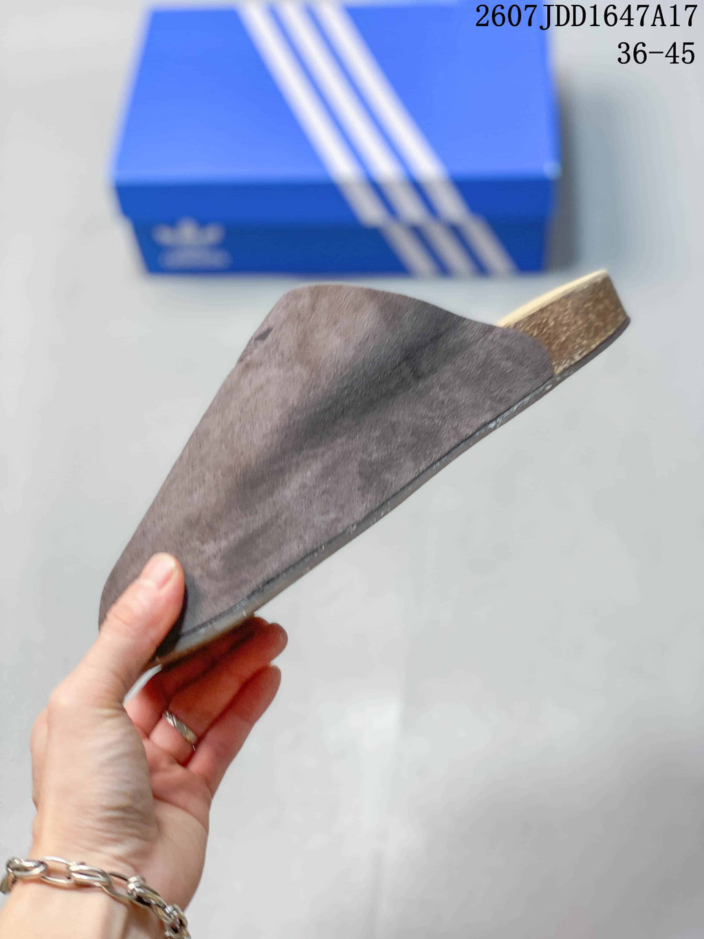 Side profile of the brown taupe slip-on clog showing its closed toe, raised heel, and layered sole.