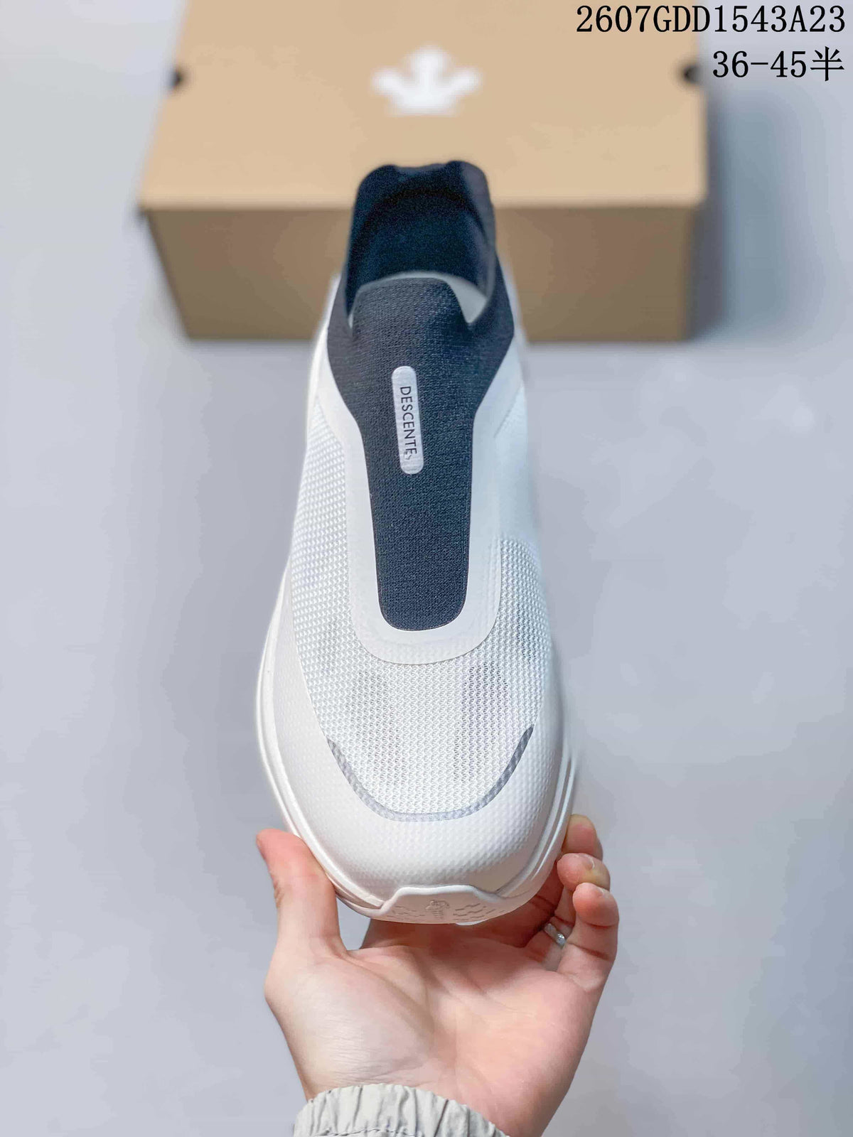 Top view showing the rounded toe, textured white upper, and navy slip-on panel