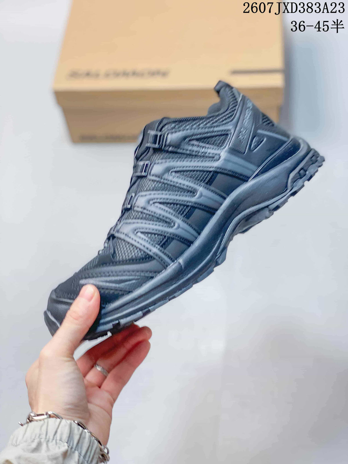 Side profile of the gray Salomon XA Pro 3D sneaker showing mesh panels, layered overlays, and the lugged outsole.
