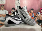 Angled view of the pair showing the patterned uppers, contrasting side branding, white laces and grey outsoles.
