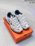 Pair of white and dark gray Nike Initiator sneakers displayed on an orange shoe box.