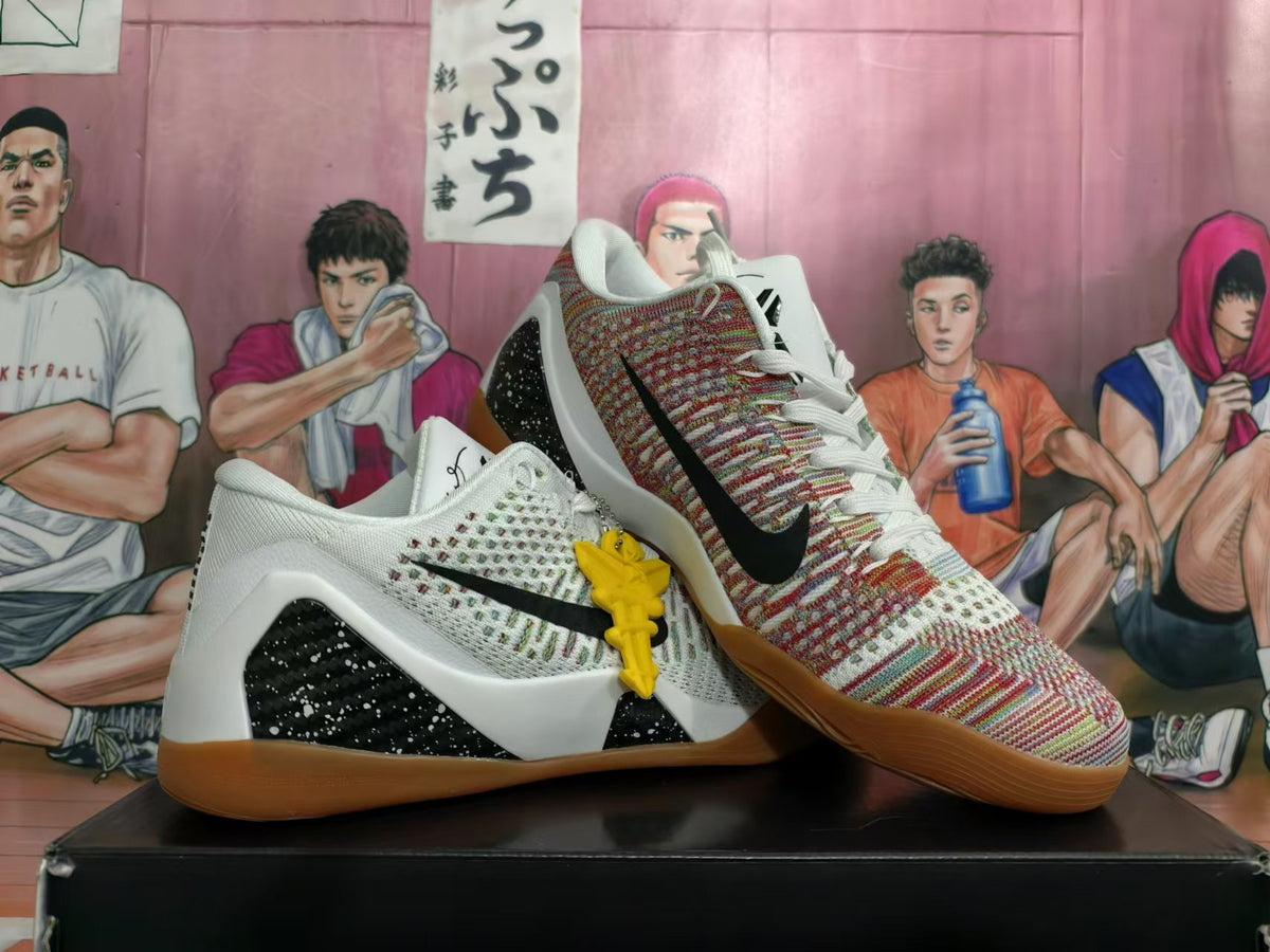 Pair of white basketball shoes with patterned panels, black logos and gum-colored outsoles