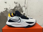 Side view showing the Swoosh logo on a white and navy Nike basketball shoe